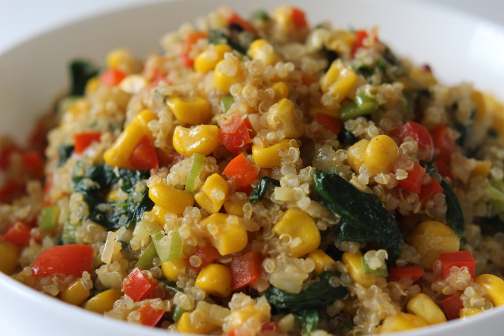 quinoa mixed with spinach, corn, and bell peppers
